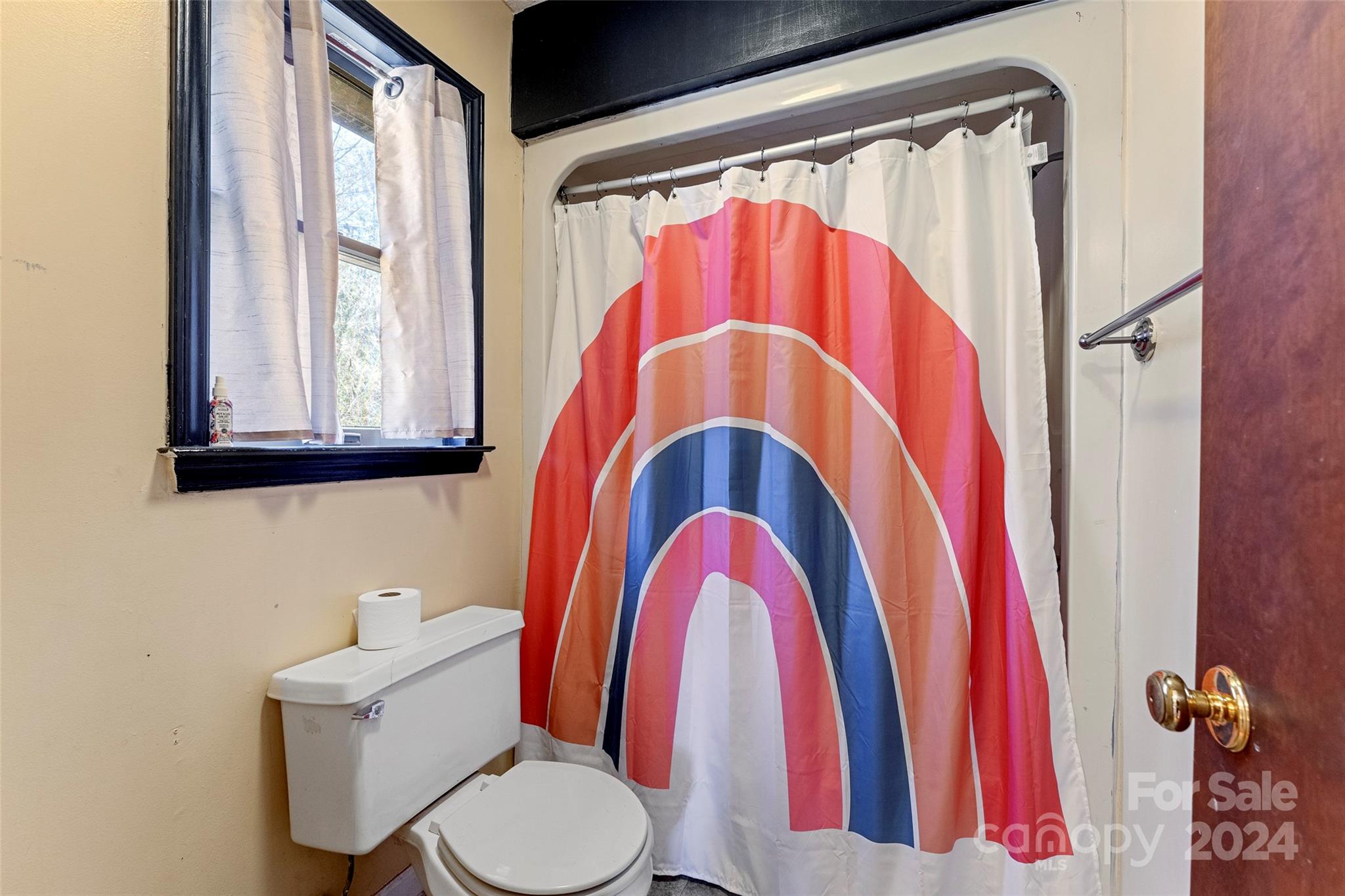 616 Oak Grove Road Flat Rock, NC 28731 - Photo 14 of 36 a bathroom with a toilet and a shower curtain