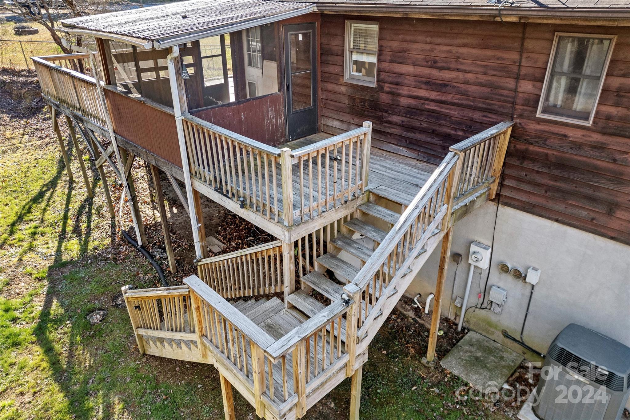 616 Oak Grove Road Flat Rock, NC 28731 - Photo 31 of 36 a view of balcony with wooden stairs and white walls