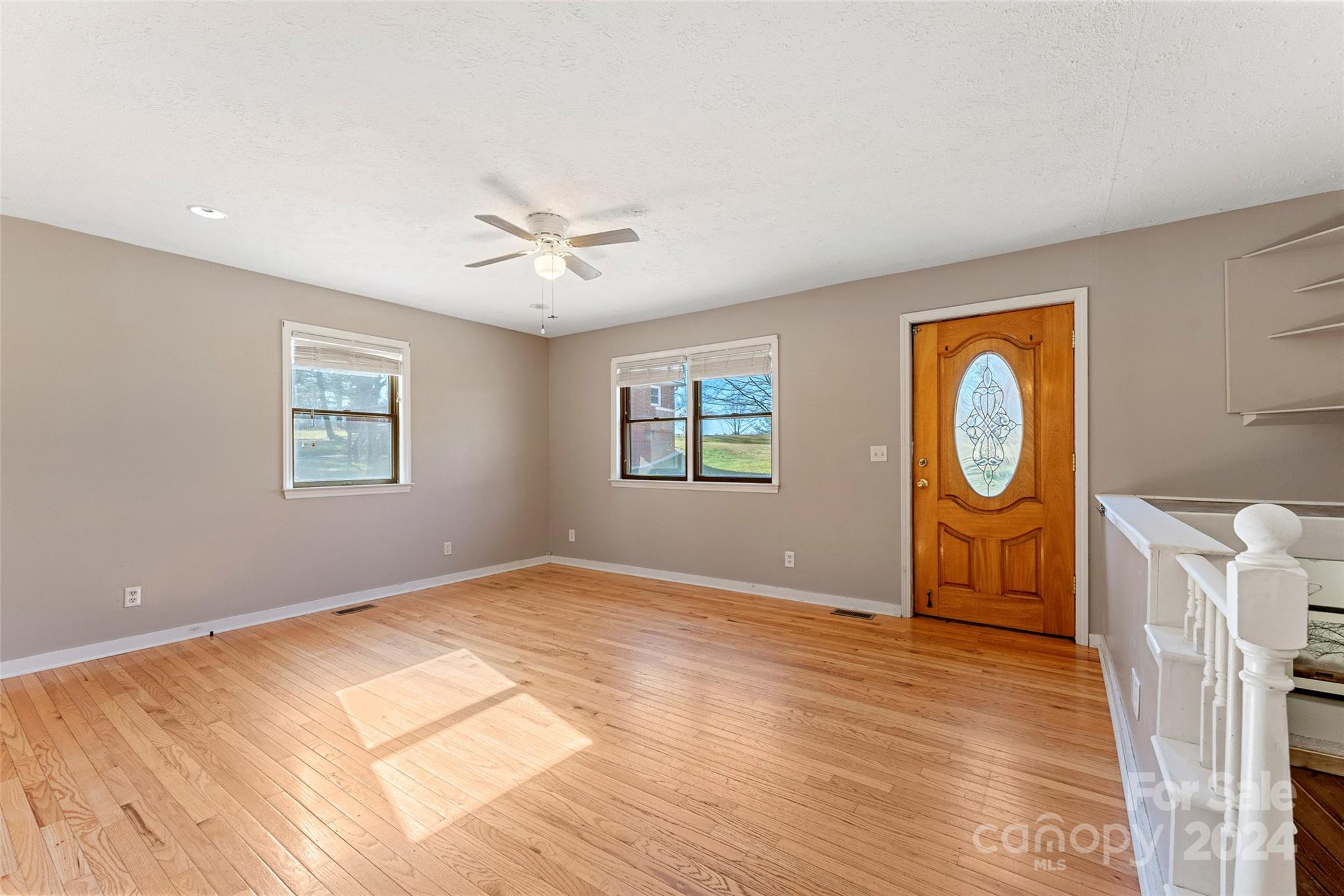 616 Oak Grove Road Flat Rock, NC 28731 - Photo 4 of 36 a view of an empty room with window and wooden floor