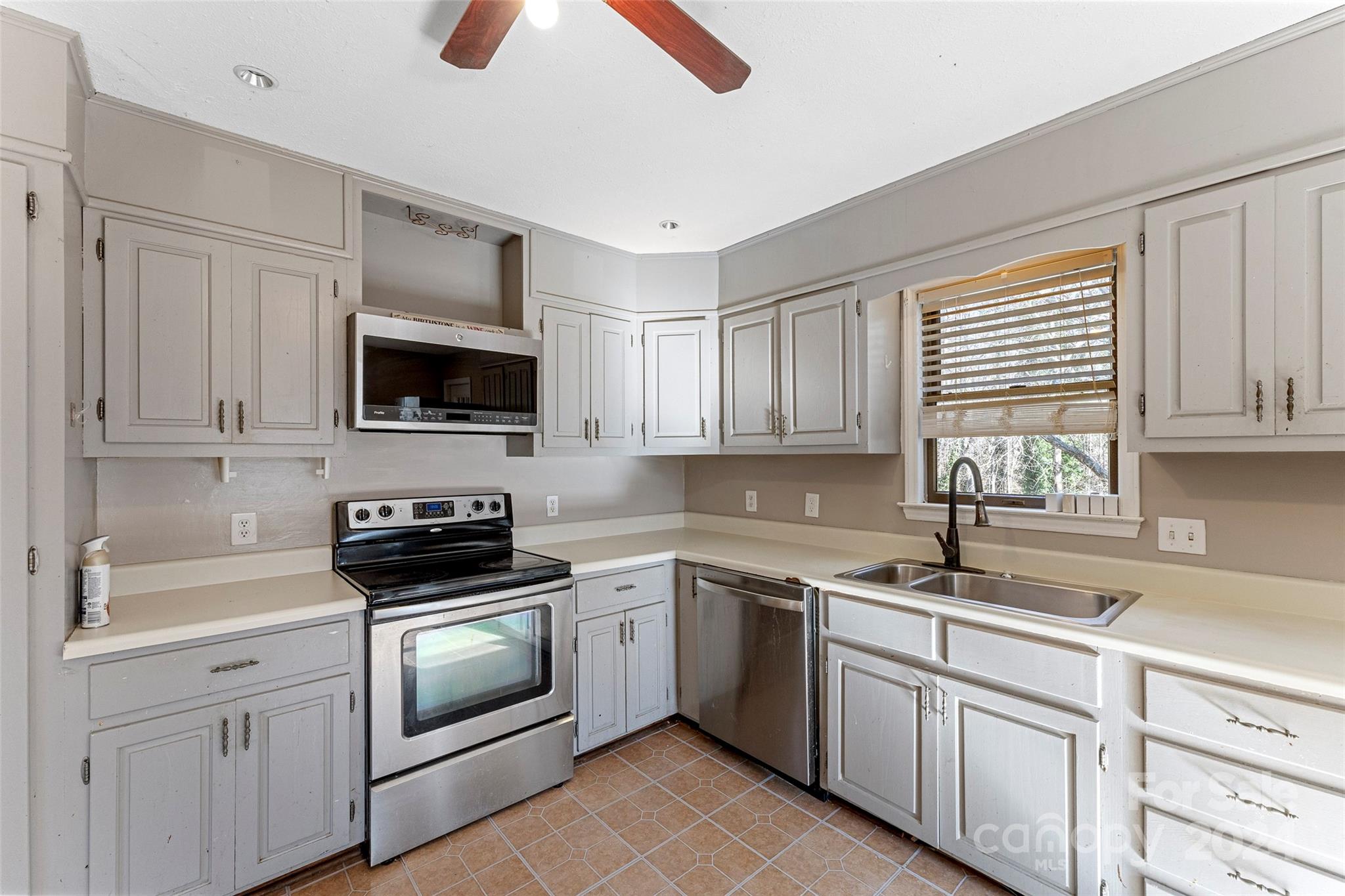 616 Oak Grove Road Flat Rock, NC 28731 - Photo 7 of 36 a kitchen with cabinets stainless steel appliances a sink and a window