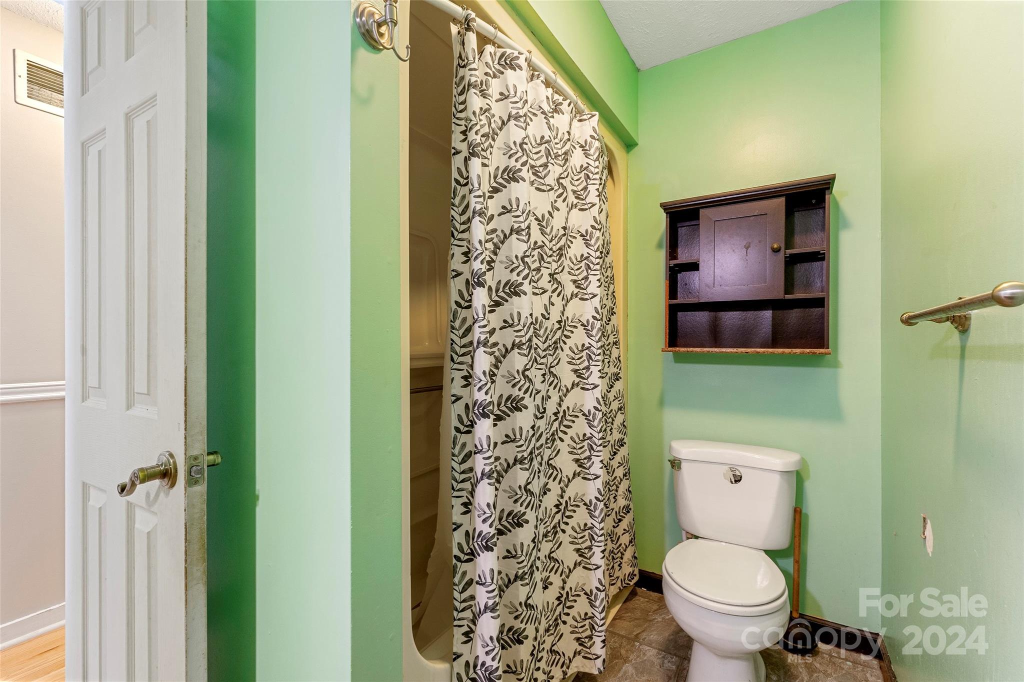 616 Oak Grove Road Flat Rock, NC 28731 - Photo 10 of 36 a bathroom with a toilet and a shower curtain