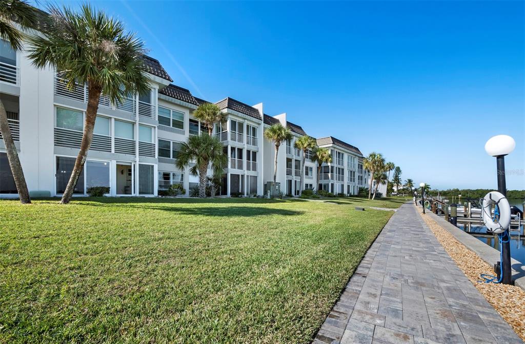 4430 Exeter Drive, Unit 106 Longboat Key, FL 34228 - Photo 16 of 57 a view of a house with a yard and potted plants