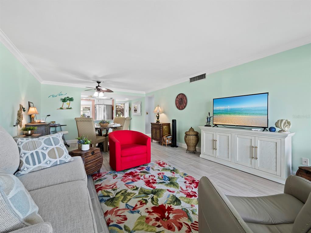 4430 Exeter Drive, Unit 106 Longboat Key, FL 34228 - Photo 17 of 57 a living room with furniture and a flat screen tv