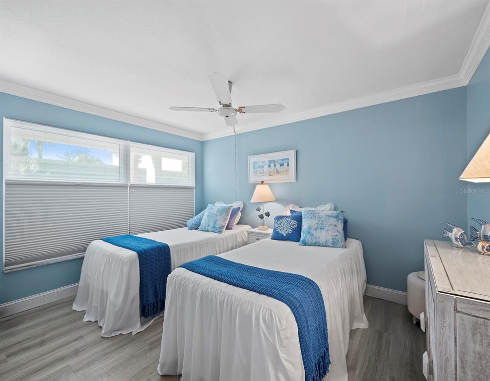 4430 Exeter Drive, Unit 106 Longboat Key, FL 34228 - Photo 18 of 57 a bedroom with two beds and a window