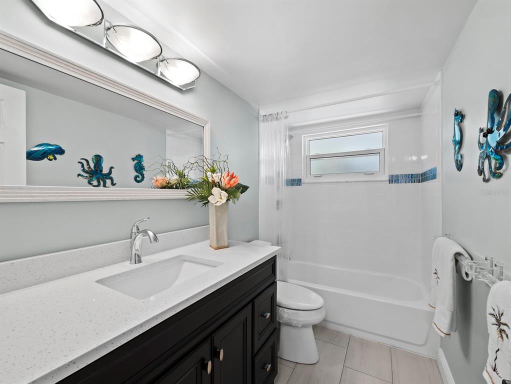 4430 Exeter Drive, Unit 106 Longboat Key, FL 34228 - Photo 19 of 57 a bathroom with a sink a toilet and a bathtub