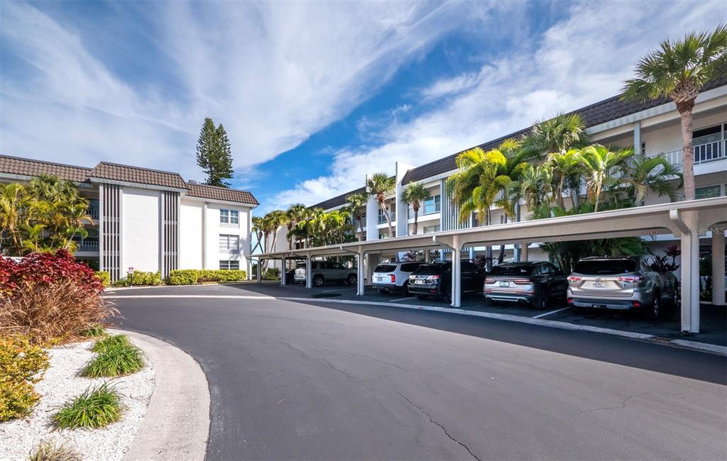 4430 Exeter Drive, Unit 106 Longboat Key, FL 34228 - Photo 32 of 57 a view of a cars park in front of a building