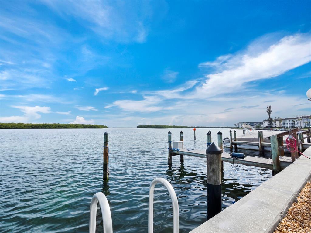 4430 Exeter Drive, Unit 106 Longboat Key, FL 34228 - Photo 46 of 57 a view of roof deck with two chairs and wooden floor