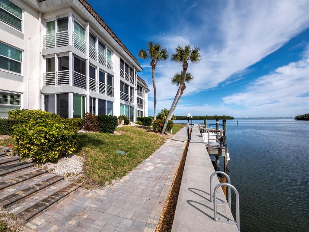 4430 Exeter Drive, Unit 106 Longboat Key, FL 34228 - Photo 50 of 57 a view of a building with a garden