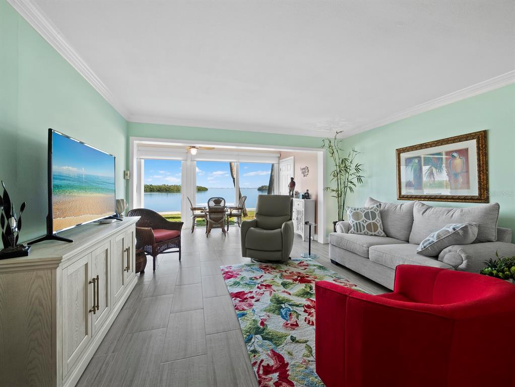 4430 Exeter Drive, Unit 106 Longboat Key, FL 34228 - Photo 7 of 57 a living room with furniture and a flat screen tv