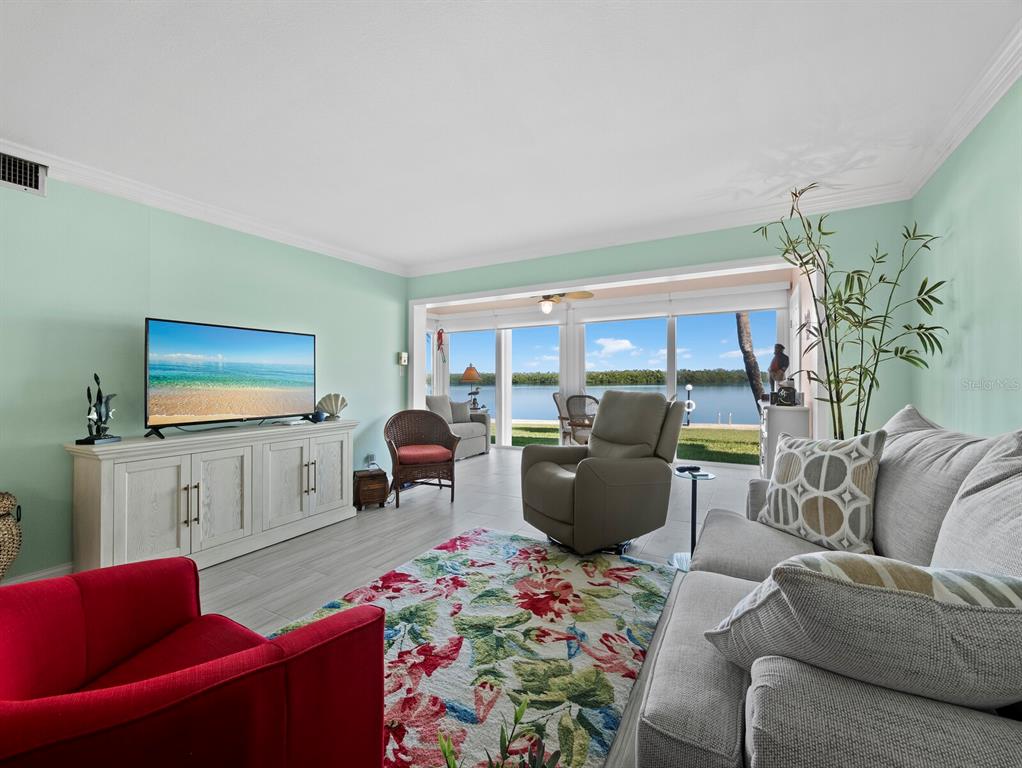 4430 Exeter Drive, Unit 106 Longboat Key, FL 34228 - Photo 8 of 57 a living room with furniture and a flat screen tv