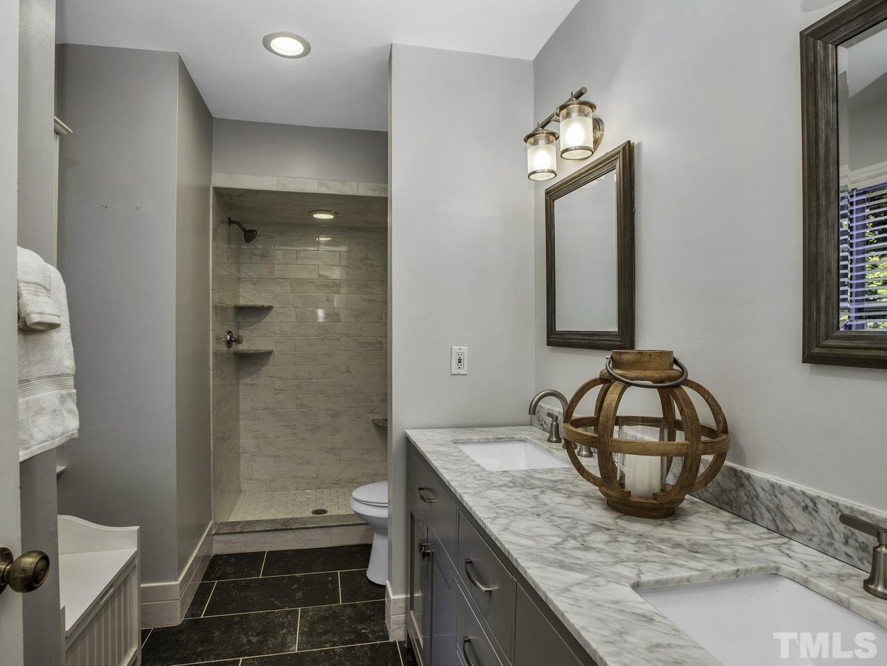4208 Webster Court Raleigh, NC 27609 - Photo 14 of 28 a bathroom with a granite countertop sink and a mirror