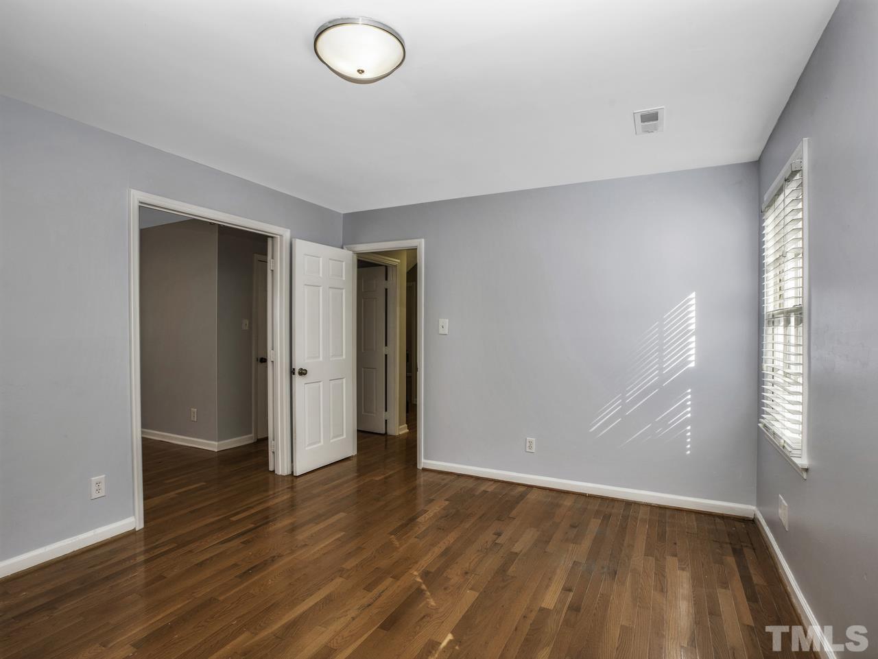 4208 Webster Court Raleigh, NC 27609 - Photo 15 of 28 an empty room with wooden floor and windows