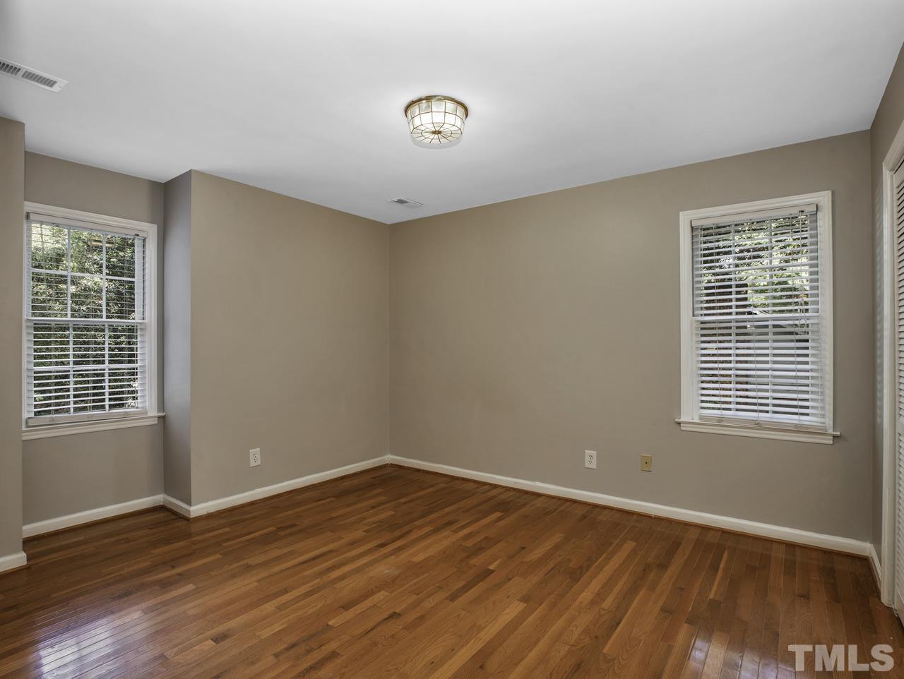 4208 Webster Court Raleigh, NC 27609 - Photo 17 of 28 a view of an empty room with wooden floor and a window