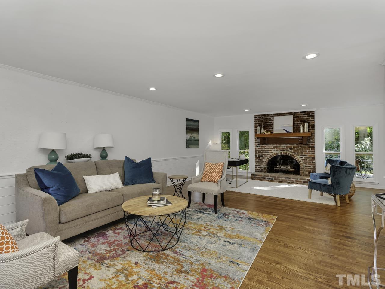 4208 Webster Court Raleigh, NC 27609 - Photo 3 of 28 a living room with furniture and a fireplace