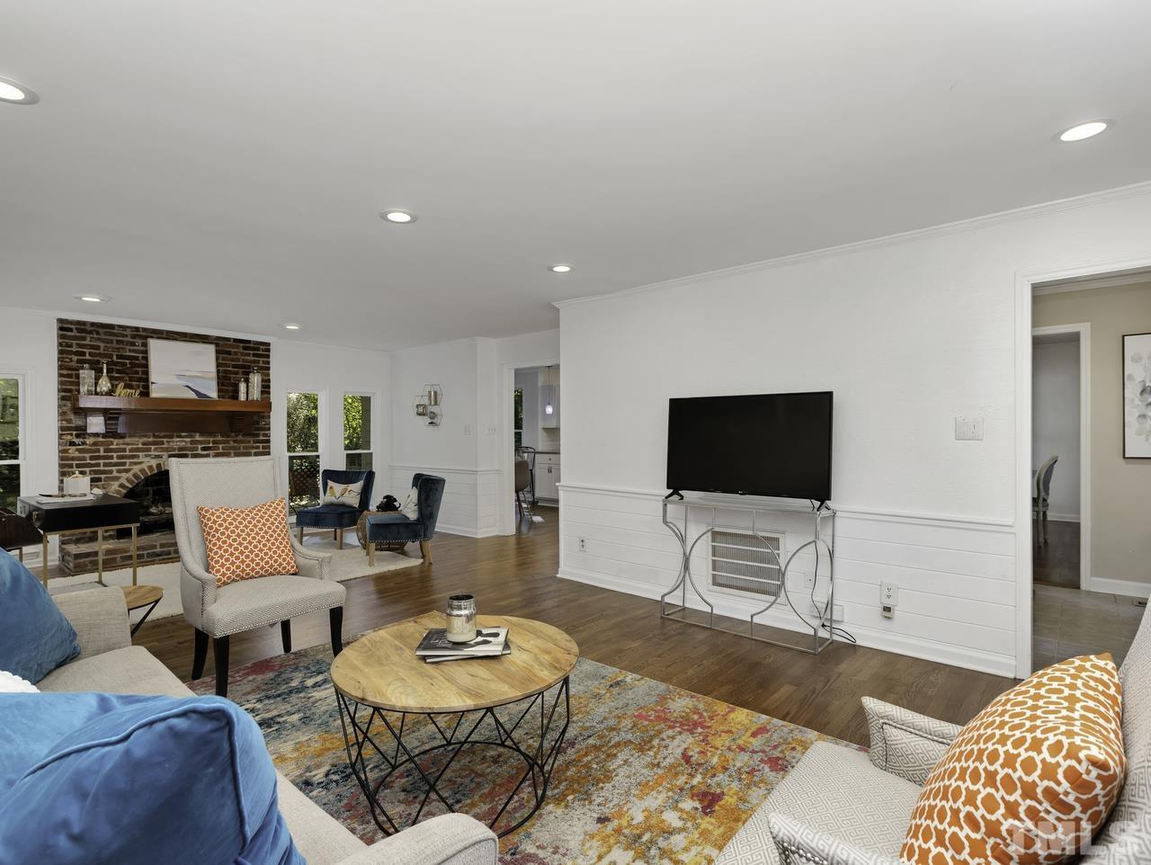 4208 Webster Court Raleigh, NC 27609 - Photo 5 of 28 a living room with furniture and a flat screen tv