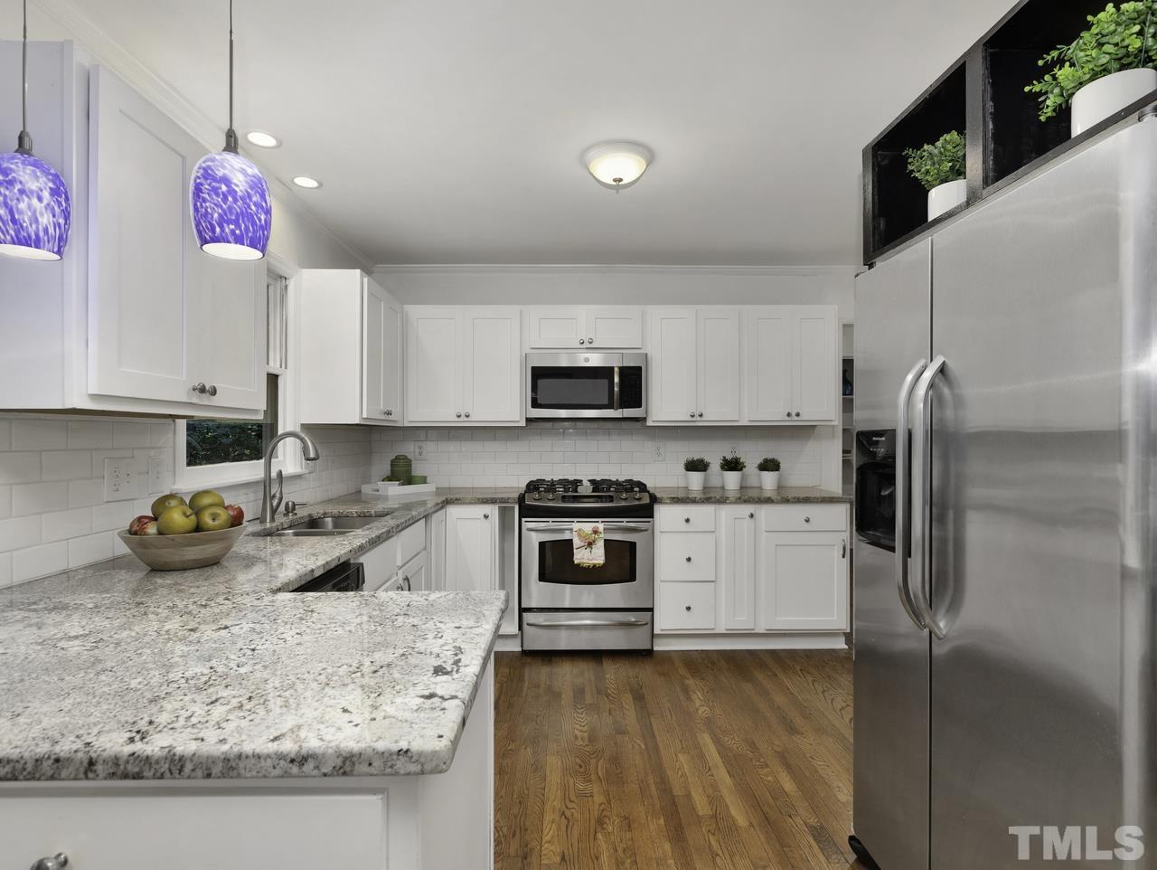 4208 Webster Court Raleigh, NC 27609 - Photo 7 of 28 a kitchen with stainless steel appliances granite countertop a refrigerator a stove top oven a sink and dishwasher