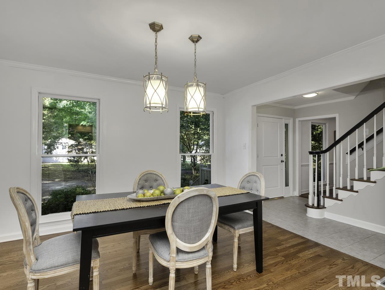 4208 Webster Court Raleigh, NC 27609 - Photo 10 of 28 a dining room with furniture a window and wooden floor