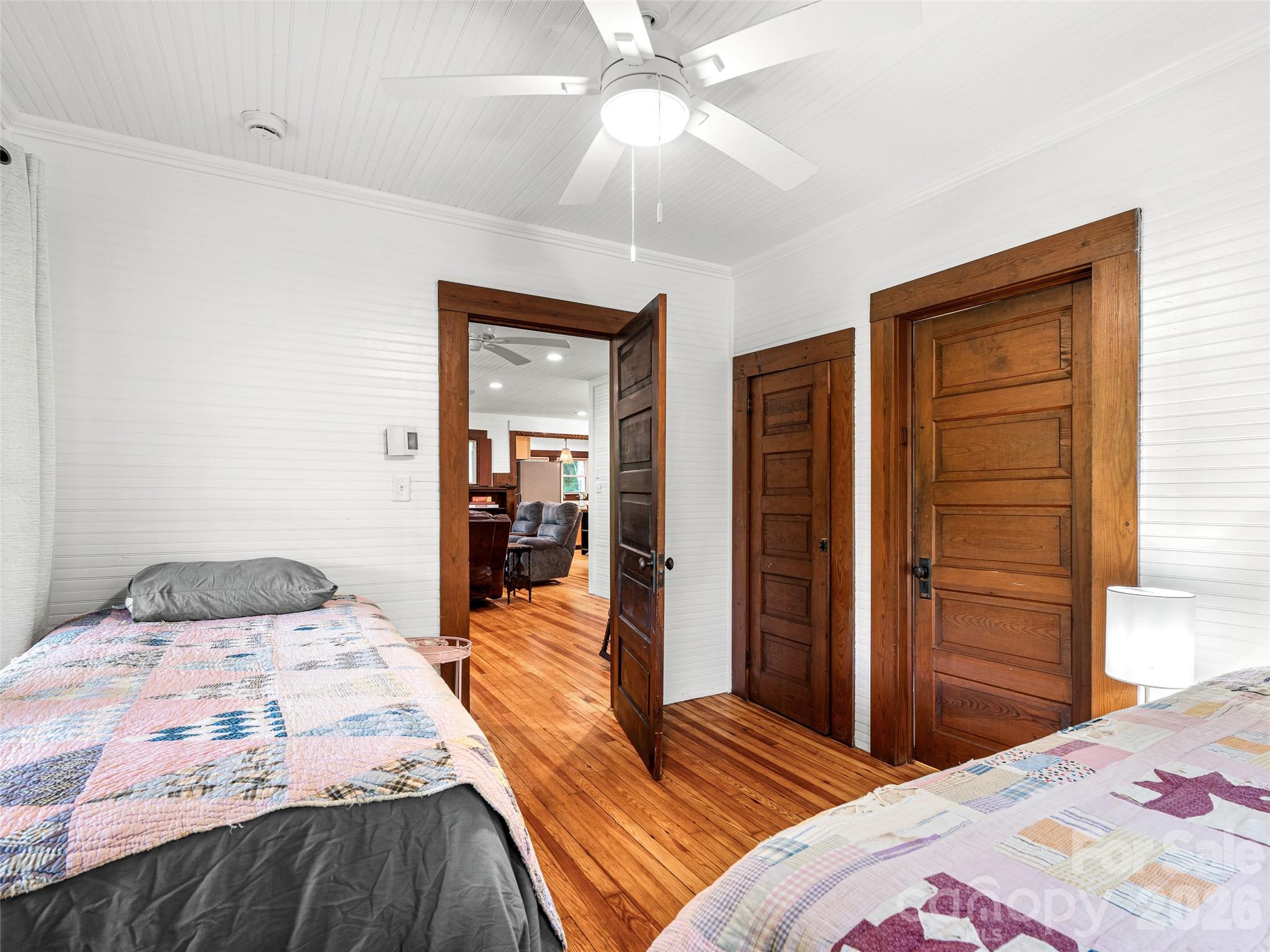 206 Chestnut Hill Road Gerton, NC 28735 - Photo 33 of 48 a bedroom with a bed and a chandelier