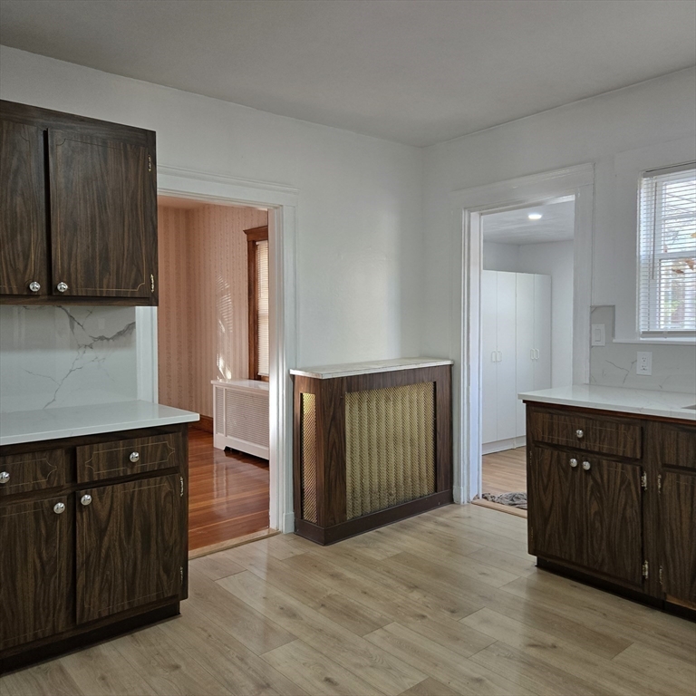 22 Hope Avenue, Unit 22 Milton, MA 02186 - Photo 12 of 36 a view of a kitchen with wooden floor and cabinets