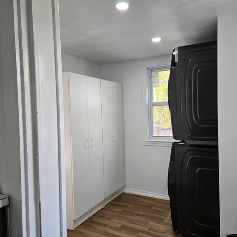 a view of walk in closet with wooden floor