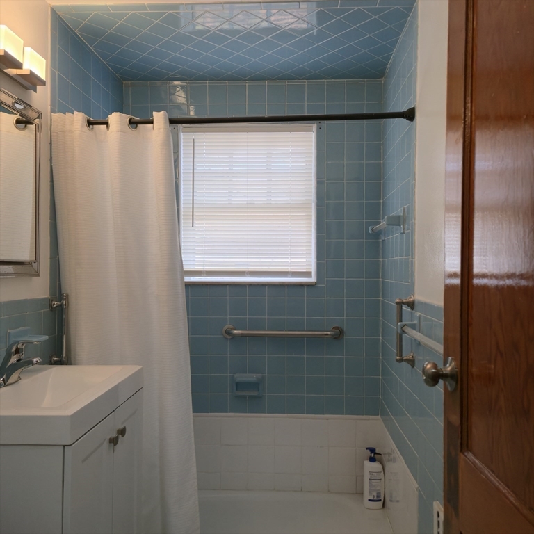 22 Hope Avenue, Unit 22 Milton, MA 02186 - Photo 16 of 36 a bathroom with a shower curtain and a sink