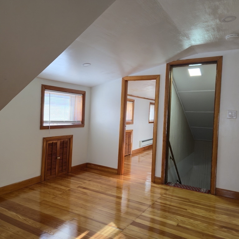 22 Hope Avenue, Unit 22 Milton, MA 02186 - Photo 18 of 36 a view of an empty room with wooden floor and a window