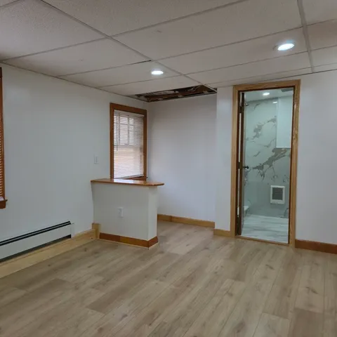 wooden floor in an empty room with a window
