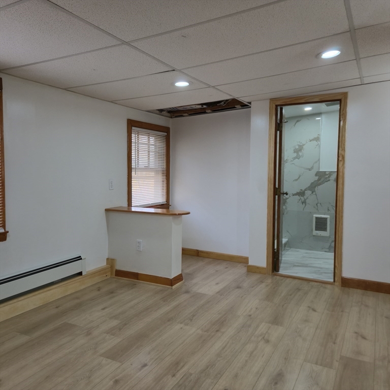 22 Hope Avenue, Unit 22 Milton, MA 02186 - Photo 24 of 36 an empty room with wooden floor and mirror
