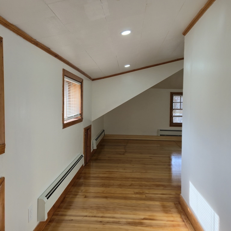 22 Hope Avenue, Unit 22 Milton, MA 02186 - Photo 27 of 36 a view of an empty room with wooden floor