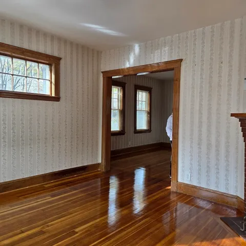 a view of hallway with wooden floor and stairs