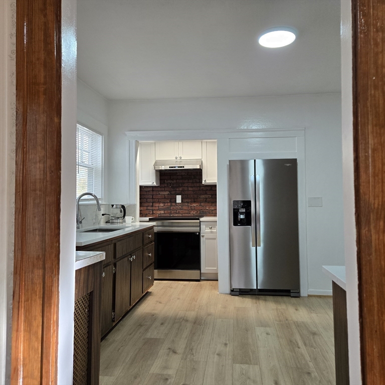 22 Hope Avenue, Unit 22 Milton, MA 02186 - Photo 9 of 36 a kitchen with stainless steel appliances granite countertop a stove a sink and a refrigerator