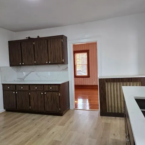 a kitchen with wooden cabinets and a sink