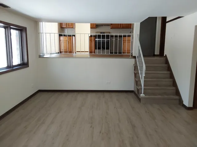 a view of a house with entryway and wooden floor