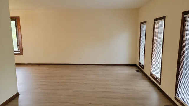 a view of a room with wooden floor and wall