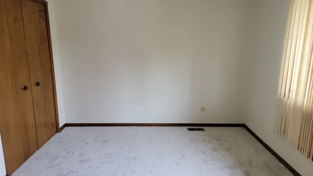 a view of an empty room and a window