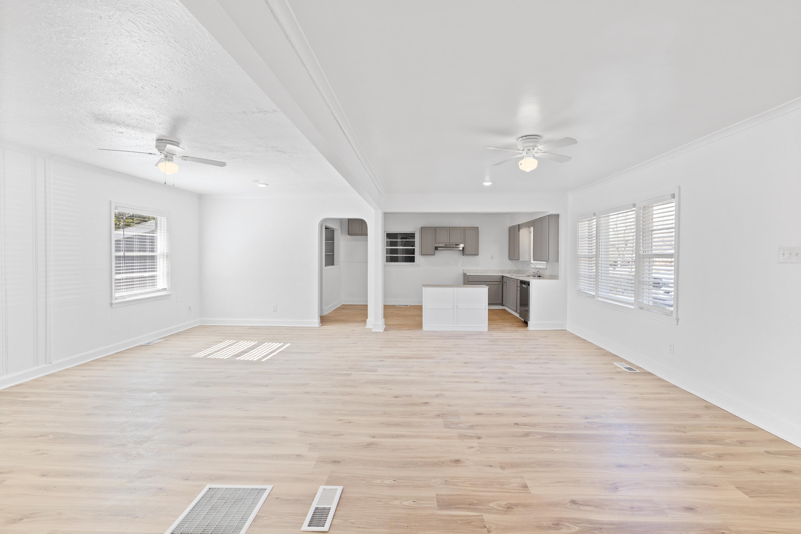 1481 East Holmes Road Memphis, TN 38116 - Photo 5 of 22 Unfurnished living room with ceiling fan, plenty of natural light, a textured ceiling, and light wood-type flooring