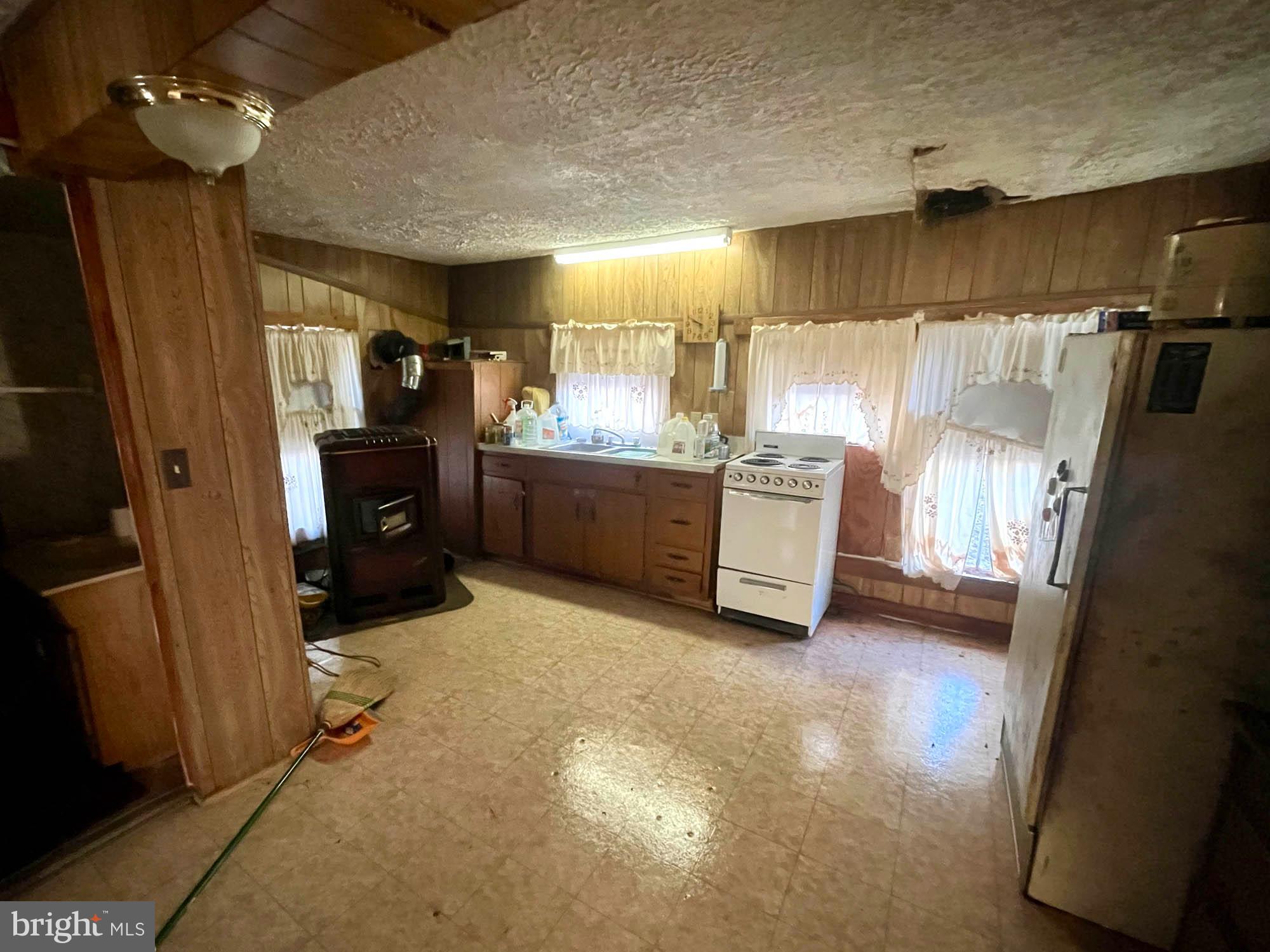 49220 Curleys Road Ridge, MD 20680 - Photo 18 of 24 a kitchen with refrigerator and window