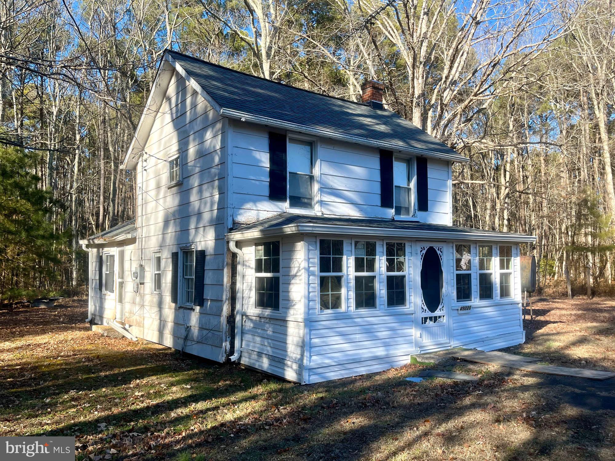 49220 Curleys Road Ridge, MD 20680 - Photo 2 of 24 a view of a white house with large windows