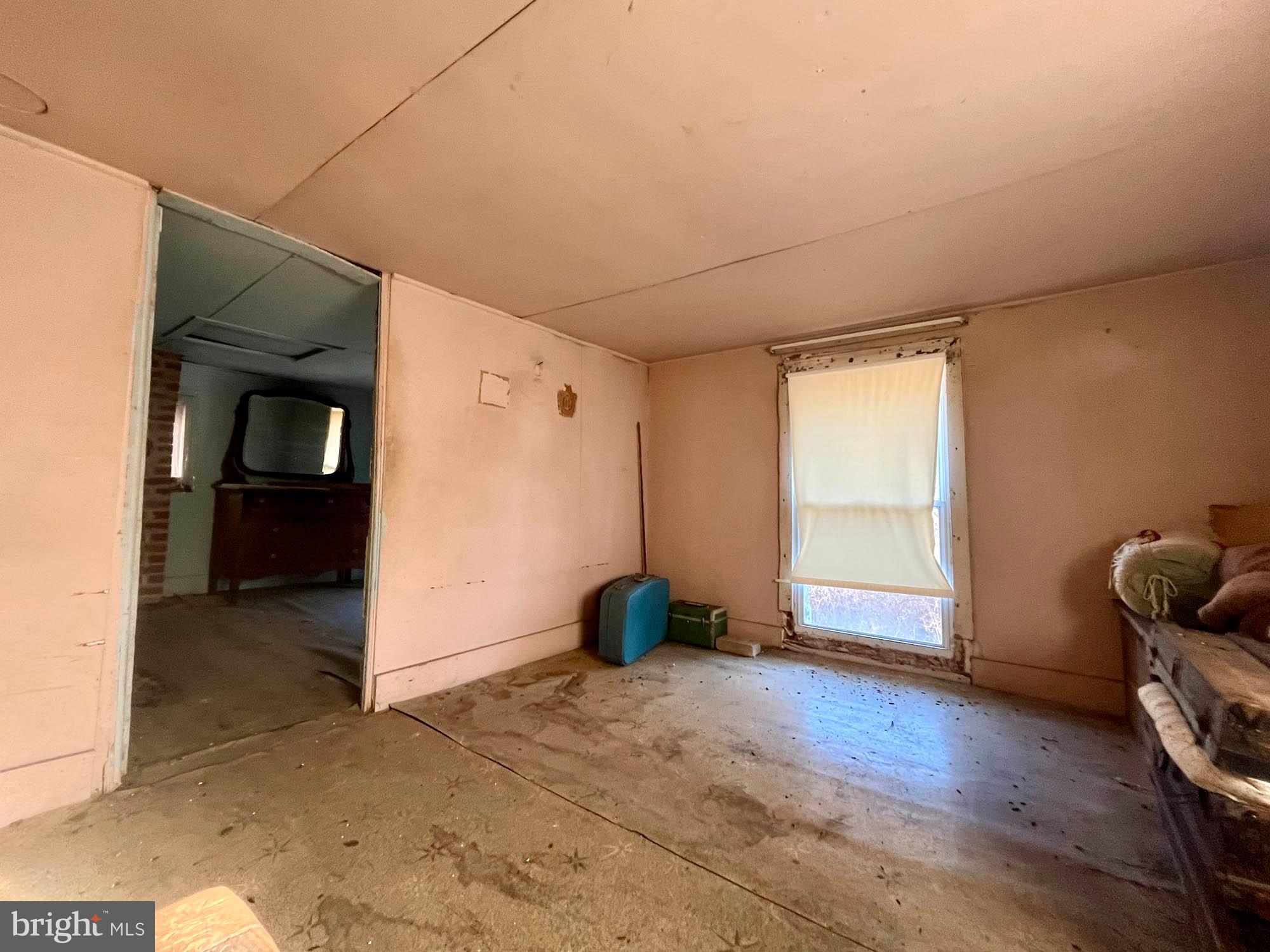 49220 Curleys Road Ridge, MD 20680 - Photo 21 of 24 an empty room with wooden floor and windows