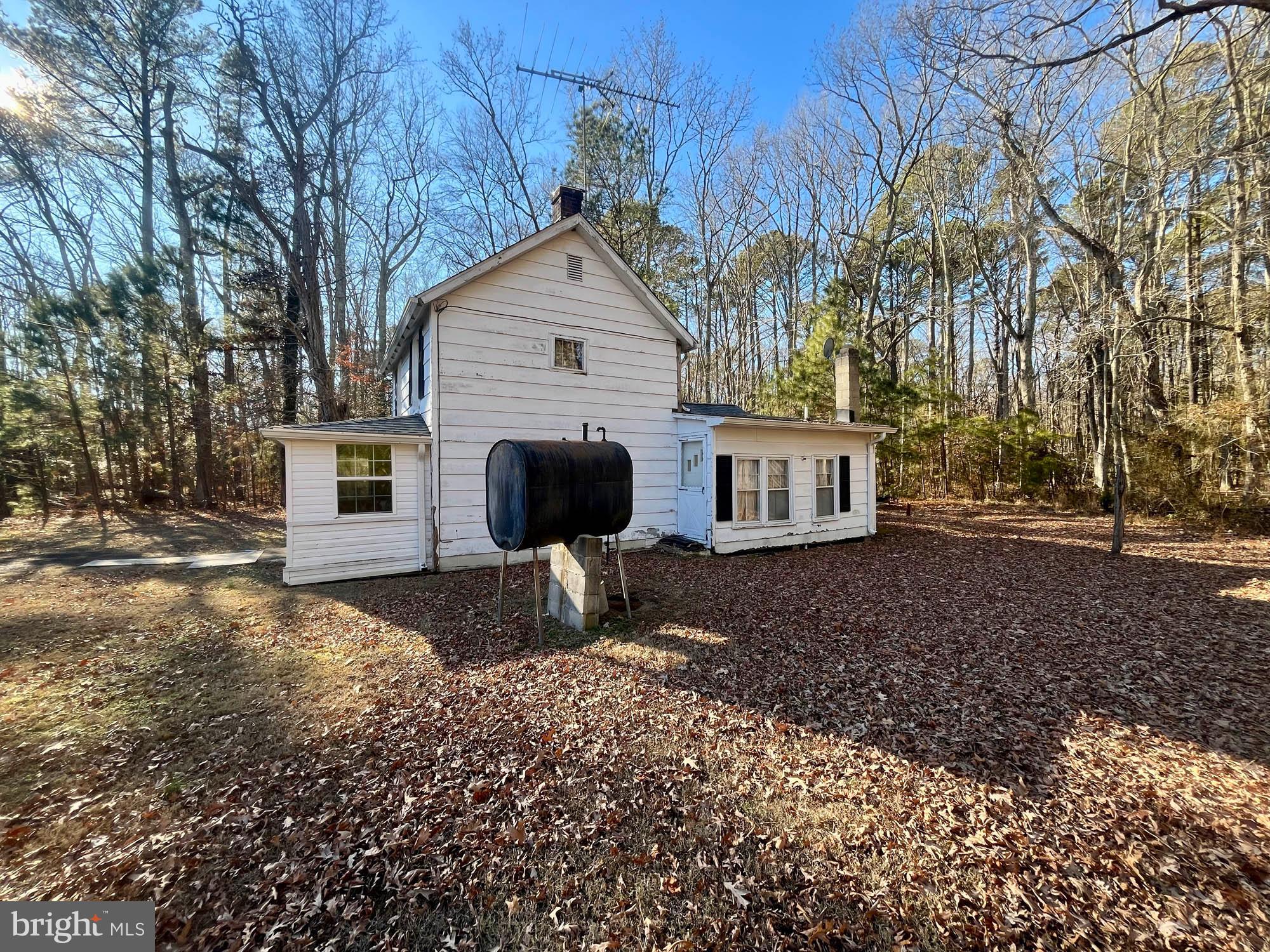 49220 Curleys Road Ridge, MD 20680 - Photo 5 of 24 a front view of a house with garden