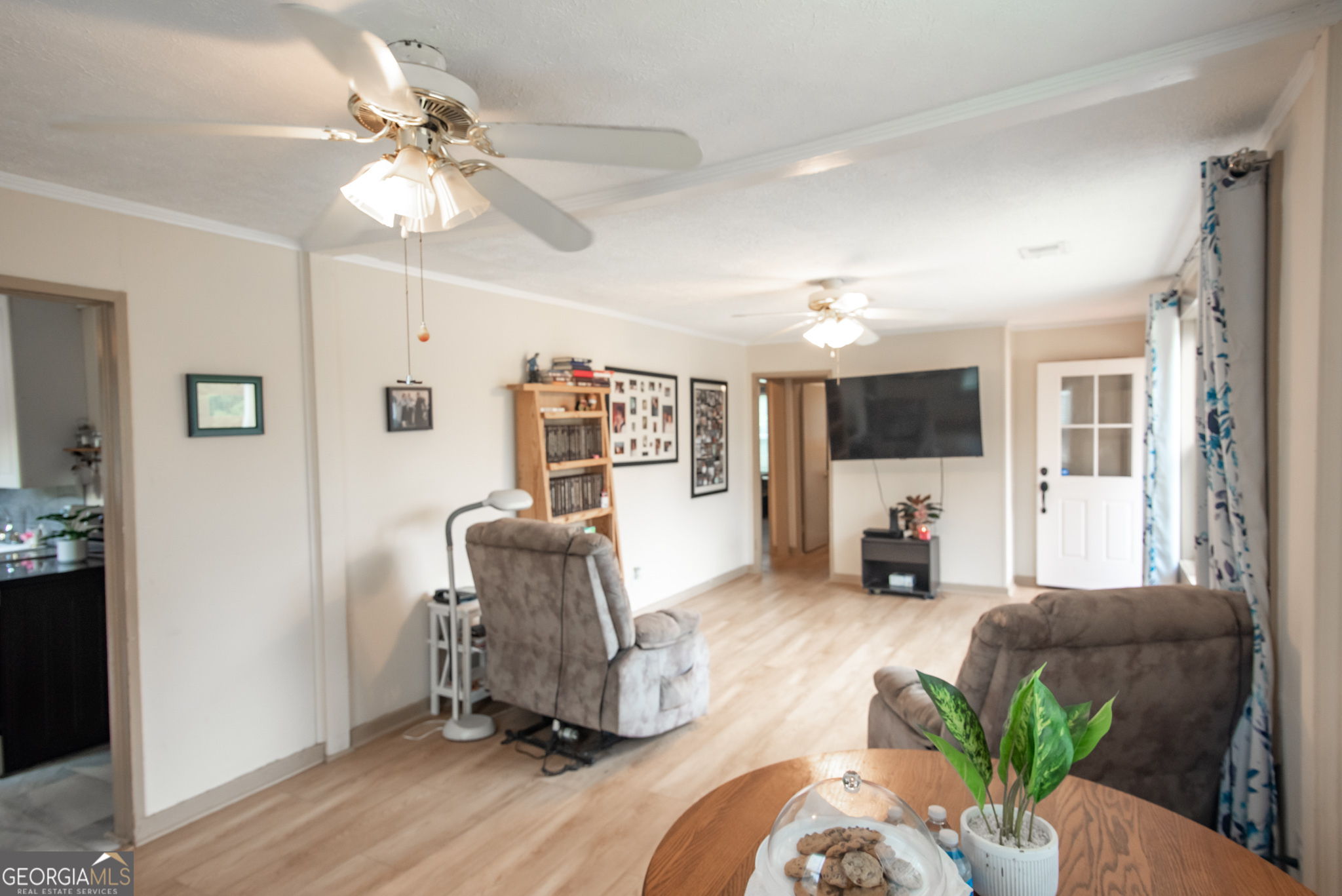 12 Bailey Drive Newnan, GA 30263 - Photo 11 of 35 a living room with furniture and a chandelier