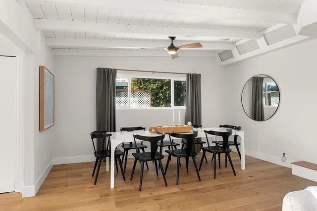 a view of a dining room with furniture and a chandelier