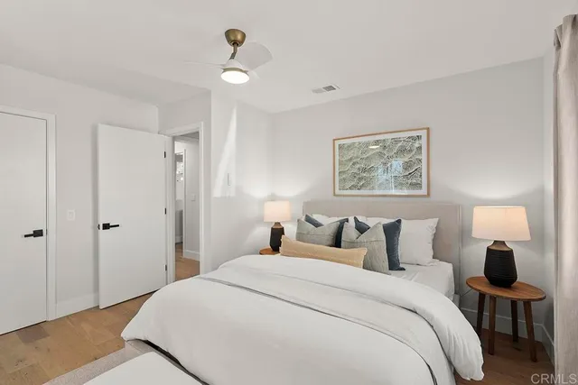 a bedroom with a large bed and a window