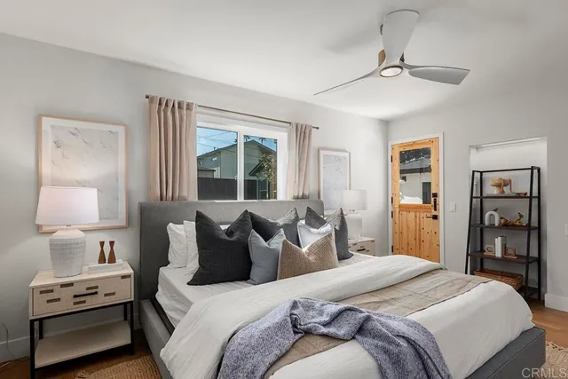 a bedroom with a bed and wooden floor