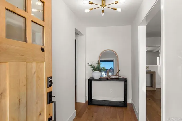 a view of living room with kitchen island furniture and wooden floor