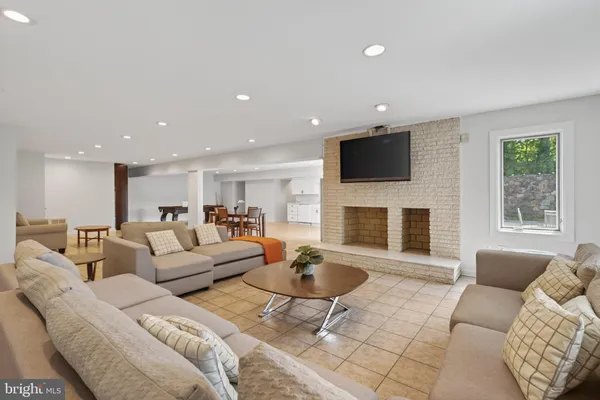 a living room with furniture a fireplace and a flat screen tv