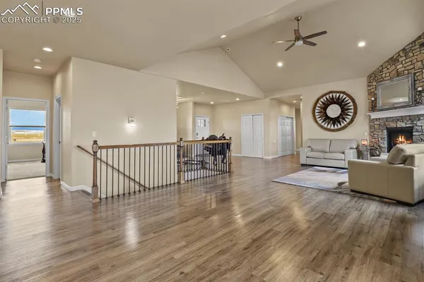 a living room with furniture and wooden floor