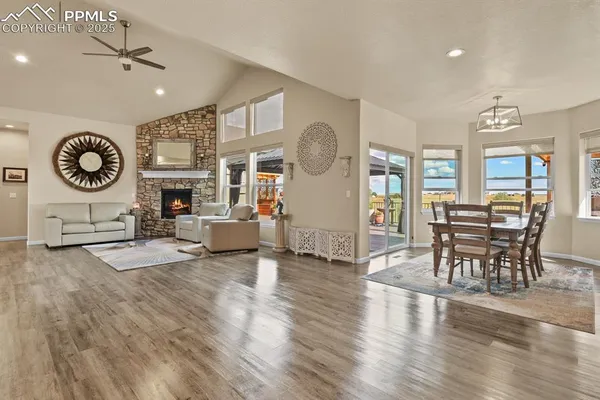 a living room with furniture a fireplace and wooden floor