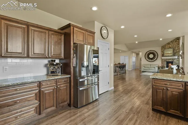 a kitchen with stainless steel appliances granite countertop a stove and a refrigerator