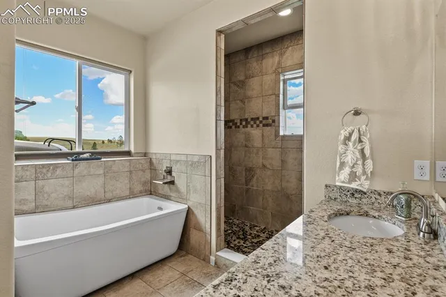 a bathroom with a tub sink and shower